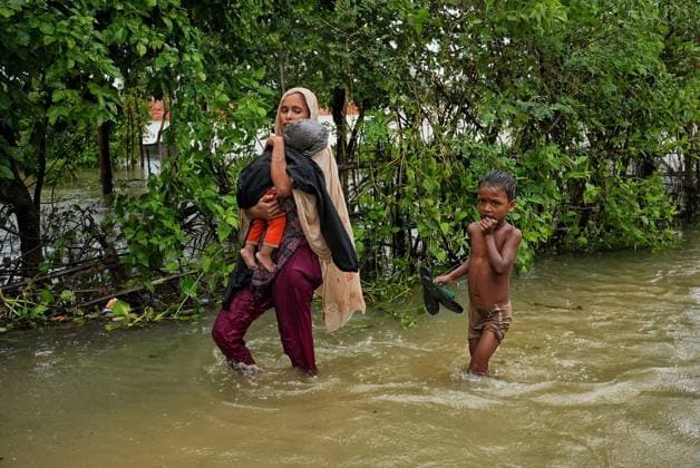 July 10, 2026, Banshkhali, Bangladesh: BANSHKHALI, CHATTOGRAM, BANGLADESH Ã¢â‚¬ JULY 10, 2026: Residents wade through floodwaters and evacuate children and belongings after days of heavy monsoon rainfall, runoff from surrounding hills and high tides caused severe flooding in Banshkhali Upazila, Chattogram. Hundreds of homes, roads and agricultural land have been inundated, leaving many families stranded and increasing concerns over access to shelter, clean water and essential services. Authorities and local volunteers continue to monitor the situation as affected residents wait for floodwaters to recede. Photos by JNA PRESS. Banshkhali Bangladesh  - ZUMAq101 20260710_zna_q101_063 Copyright: xIstiyakxAhamedxSrabonx