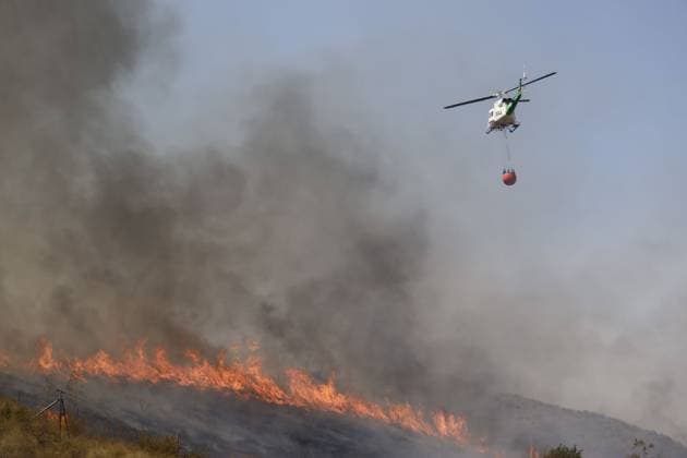 July 10, 2026, Almeria, ES: ALMERIA, SPAIN - JULY 10: An exhausted firefighter rests near an INFOCA emergency vehicle while a colleague holds a bottle of water during a massive wildfire in Los Gallardos, Almeria province, southern Spain, on July 10, 2026. This disaster represents the most severe fire event in the history of Andalusia, resulting in twelve confirmed fatalities, twenty-three individuals missing, and the urgent evacuation of six hundred citizens, with emergency relief teams coordinating temporary housing from the nearby town of Garrucha. Stinger Jna press Almeria ES  - ZUMAq101 20260710_zna_q101_113 Copyright: xEditorx