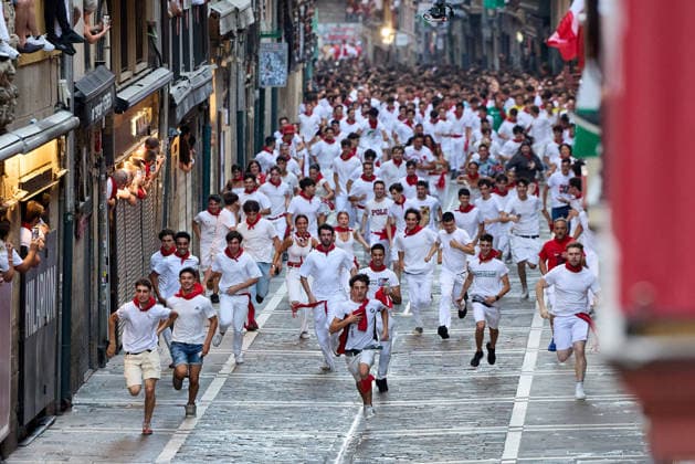 San Fermin Festival in Spain PAMPLONA, SPAIN - JULY 11: Participants wearing traditional white outfits and red scarves take part in the running with the bulls event, known as Encierro, during the San Fermin Festival in Pamplona, northern Spain, on July 11, 2026. The adrenaline-filled run covers an 875-meter stretch through the historic city center. Ruben Albarran Anadolu Pamplona Spain. Editorial use only. Please get in touch for any other usage.  Copyright: x2026xAnadoluxRubenxAlbarranx