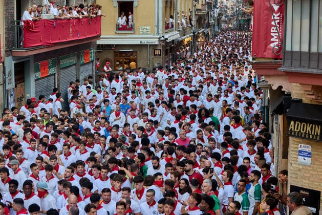 San Fermin Festival in Spain PAMPLONA, SPAIN - JULY 11: Participants wearing traditional white outfits and red scarves take part in the running with the bulls event, known as Encierro, during the San Fermin Festival in Pamplona, northern Spain, on July 11, 2026. The adrenaline-filled run covers an 875-meter stretch through the historic city center. Ruben Albarran Anadolu Pamplona Spain. Editorial use only. Please get in touch for any other usage.  Copyright: x2026xAnadoluxRubenxAlbarranx