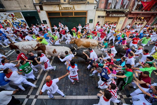San Fermin Festival in Spain PAMPLONA, SPAIN - JULY 11: Participants wearing traditional white outfits and red scarves take part in the running with the bulls event, known as Encierro, during the San Fermin Festival in Pamplona, northern Spain, on July 11, 2026. The adrenaline-filled run covers an 875-meter stretch through the historic city center. Ruben Albarran Anadolu Pamplona Spain. Editorial use only. Please get in touch for any other usage.  Copyright: x2026xAnadoluxRubenxAlbarranx