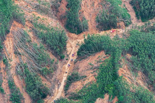 (260711) -- HENGZHOU, July 11, 2026 -- An aerial drone photo taken on July 11, 2026 shows rescuers clearing up a road leading to Zhenlong Township in Hengzhou, south China s Guangxi Zhuang Autonomous Region. One main road leading to the government seat of Zhenlong Township in the city of Hengzhou, south China s Guangxi Zhuang Autonomous Region, was preliminarily opened to traffic at around 1:30 p.m. on Saturday, Xinhua reporters at the rescue site have confirmed. With a permanent population of about 8,000, the township had been trapped as an isolated island. Hit by continuous heavy rainfall, the entire township was cut off from outside access with no open roads, power or network services starting from July 5. The opening of the mai 