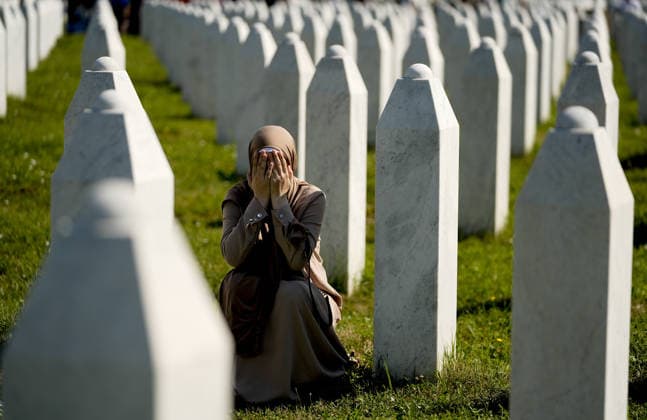 Thousands gather in Srebrenica to mark 31st anniversary of genocide as 10 more victims laid to rest POTOCARI, BOSNIA AND HERZEGOVINA - JULY 11: A woman is crying among the gravestones as relatives of victims of the 1995 Srebrenica genocide pray at the graves of their loved ones at the Potocari Memorial Cemetery in Potocari, Bosnia and Herzegovina, on July 11, 2026. Thousands of mourners, survivors, foreign dignitaries and religious leaders gathered Saturday at the Srebrenica-Potocari Memorial Center to mark the 31st anniversary of the Srebrenica genocide as the remains of 10 newly identified victims were laid to rest. The collective funeral, held every July 11, remains one of Bosnia and Herzegovina’s most solemn commemorations, as families  Copyright: x2026xAnadoluxSamirxJordamovicx