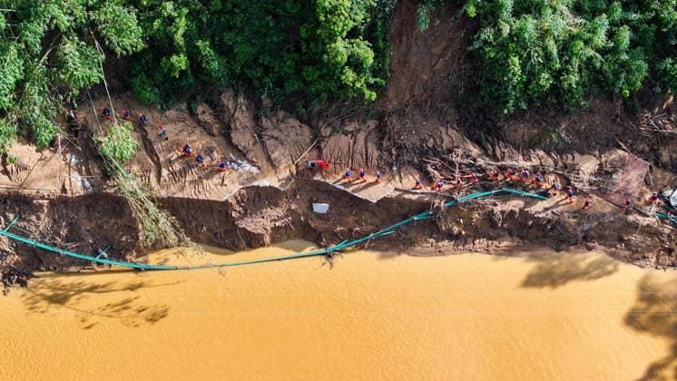 (260711) -- NANNING, July 11, 2026 -- An aerial drone photo shows rescuers heading towards Zhenlong Township of Hengzhou, south China s Guangxi Zhuang Autonomous Region, July 11, 2026. Triggered by Typhoon Maysak, the tenth typhoon of the year, heavy downpours battered multiple areas in south China s Guangxi Zhuang Autonomous Region, resulting in a series of disasters. Various response forces have pooled their efforts, carrying out operations including rescue missions in remote mountainous areas, restoration of transport and power infrastructure, and silt clearing operations. ) CHINA-GUANGXI-TYPHOON-FLOOD-RESCUE (CN) HuangxXiaobang 