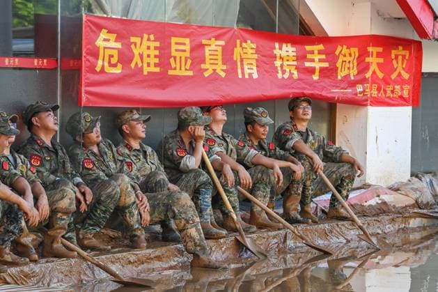 (260711) -- NANNING, July 11, 2026 -- Rescuers from other regions take a rest during breaks from silt clearing operations in Guigang, south China s Guangxi Zhuang Autonomous Region, July 10, 2026. Triggered by Typhoon Maysak, the tenth typhoon of the year, heavy downpours battered multiple areas in south China s Guangxi Zhuang Autonomous Region, resulting in a series of disasters. Various response forces have pooled their efforts, carrying out operations including rescue missions in remote mountainous areas, restoration of transport and power infrastructure, and silt clearing operations. ) CHINA-GUANGXI-TYPHOON-FLOOD-RESCUE (CN) CaoxYiming 