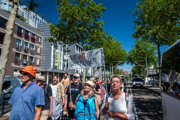 July 11, 2026, Schiedam, South Holland, Netherlands: 11 July 2026. A demonstrator holds a banner reading Exclude Hate, Not People (translated from Dutch). In Schiedam, the Netherlands, a pro-asylum seeker demonstration promoted by Extinction Rebellion countered a demonstration called the Vrouwenmars tegen het AZC (Women s March Against the AZC) promoted by anti-asylum seeker centre groups. Both events took place in the center of Schiedam. Schiedam Netherlands - ZUMAp202 20260711_zip_p202_007 Copyright: xJamesxPetermeierx