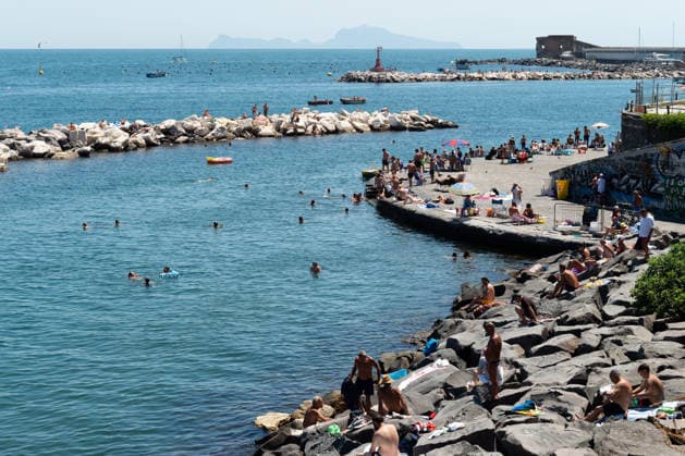 African heatwave in Naples NAPLES, ITALY - JULY 11: People sunbath and swim during the African heatwave in Naples on July 11, 2026. A new and more intense heatwave is sweeping across Italy and Western Europe, with temperatures peaking at 38-41 degrees celsius in southern Italy. Eliano Imperato Anadolu Naples Italy. Editorial use only. Please get in touch for any other usage.  Copyright: x2026xAnadoluxElianoxImperatox