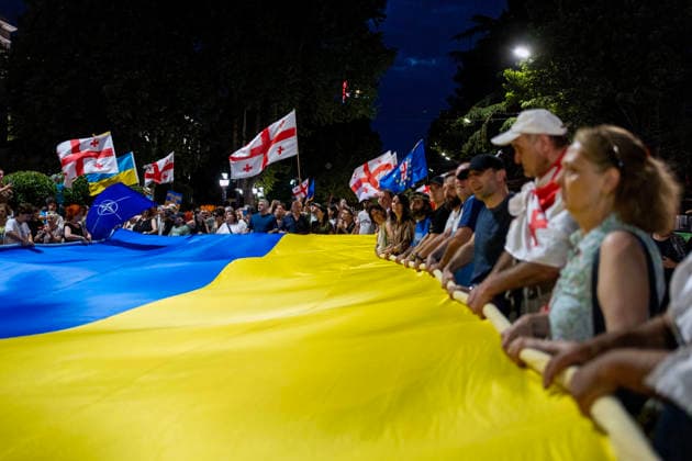 July 11, 2026, Tbilisi, Georgia: Protesters carry a large Ukrainian flag as they mark 591st day of anti-government rally in Tbilisi, Georgia. Tbilisi Georgia - ZUMAz174 20260711_zip_z174_006 Copyright: xMoexZoyarix
