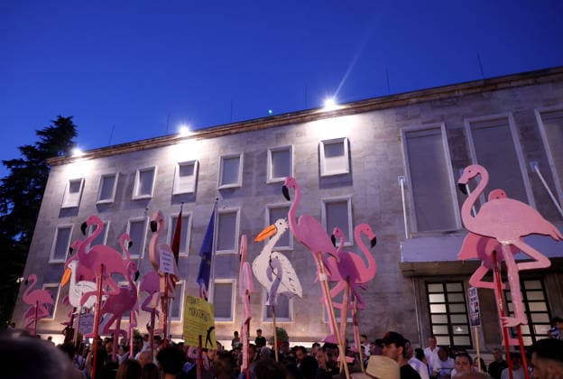 July 11, 2026, Tirane, Albania, ALB: Protesters hold signs and Albanian national flags as they take part in a demonstration in front of the PM office in Tirana on July 11, 2026, opposing the construction of a luxury resort in a protected natural area near the city of Vlore. Several thousand citizens demonstrated in Tirana for the 42nd consecutive night to demand transparency on a luxury tourism complex project in the protected area of Narta Lagoon in the city of Vlore linked to US President Donald Trump s son-in-law, Jared Kushner, and his wife, Ivanka Trump. The project was planned for two areas along the Adriatic coast: the protected delta area of Vjosa-Narta and the nearby uninhabited island of Sazan. Tirane ALB  - ZUMAs337 20260711_znp_s337_016 Copyright: xGentxShkullakux