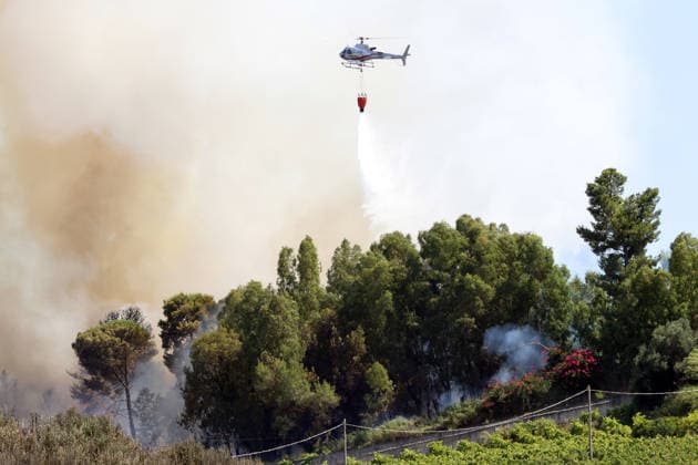 Wildfires continue on the Italian island of Sicily PALERMO, ITALY - JULY 11: Smoke rises after a wildfire that breaks out in a maquis-shrubland area near the Partinico municipality of Palermo in Sicily, Italy on July 11, 2026. Firefighting teams intervened with ground crews, water-discharging aircraft, and helicopters to bring the blaze under control Alberto Lo Bianco Anadolu Sicily Italy. Editorial use only. Please get in touch for any other usage.  Copyright: x2026xAnadoluxAlbertoxLoxBiancox