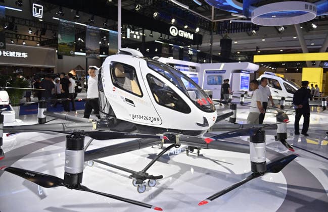 CHANGCHUN, CHINA - JULY 11: Visitors view an EHang 216-S electric vertical takeoff and landing (eVTOL) aircraft during the 23rd Changchun International Automobile Expo on July 11, 2026 in Changchun, Jilin Province of China. The exhibition drew participation from 53 Chinese and foreign automobile manufacturers, with over a thousand vehicles on display.  Copyright: xChinaxNewsxServicex 111653661096