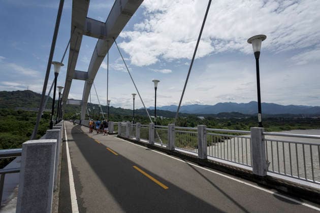 July 12, 2026, Taichung, Taiwan: People walk along the bikeway bridge over Dajia River in Taichung, Taiwan. The Central Weather Administration (CWA) lifted its land and sea warnings for Typhoon Bavi on Sunday morning as the storm weakened and moved away from Taiwan, after bringing heavy rain and strong winds to parts of the country. Taichung Taiwan  - ZUMAc217 20260712_zip_c217_005 Copyright: xAndrexM.xChangx