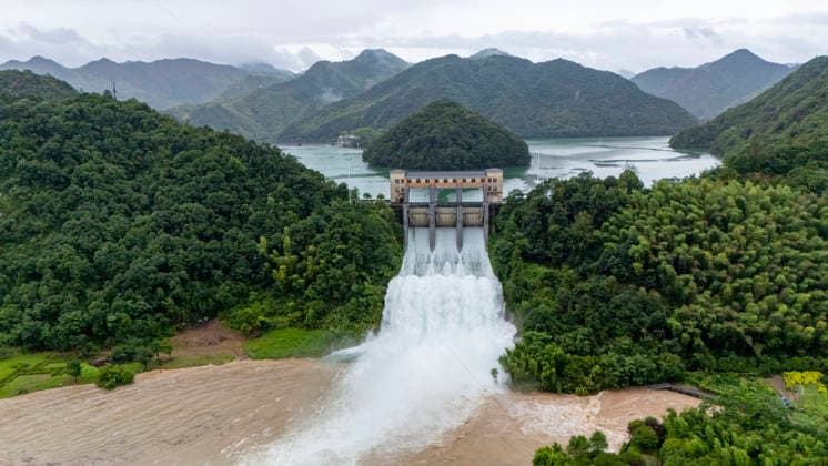 JINHUA, CHINA - JULY 12: In an aerial view, sluice gates of Andi Reservoir open to release flood water on July 12, 2026 in Jinhua, Zhejiang Province of China. Affected by Typhoon Bavi, Andi Reservoir in Jinhua recorded a water level of 125.71 meters on July 12, close to its flood threshold.  Copyright: xVCGx 111653805743