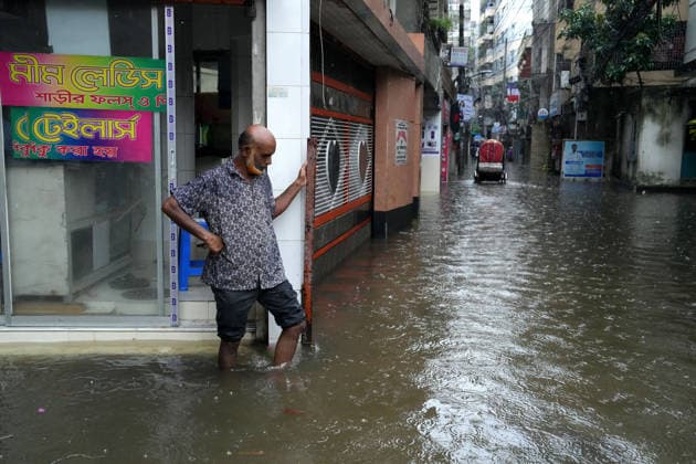 July 12, 2026, Dhaka, Dhaka, Bangladesh: A man looks at a waterlogged street during heavy monsoon rainfall in Dhaka, Bangladesh. Persistent downpours have inundated large parts of the capital, disrupting daily life and transportation while forcing residents to continue their routines despite widespread flooding. Dhaka Bangladesh  - ZUMAk174 20260712_zip_k174_008 Copyright: xSyedxMahabubulxKaderx
