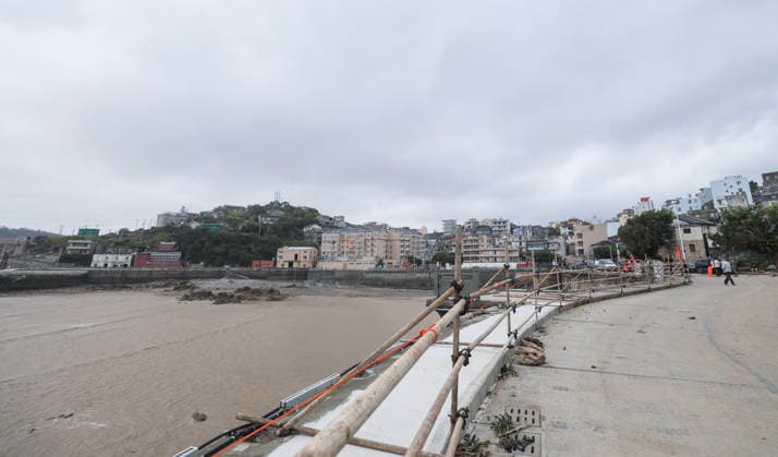 (260712) -- HANGZHOU, July 12, 2026 -- Steel frames are installed along a road where guardrails were blown down by strong winds in Yuhuan of Taizhou City, east China s Zhejiang Province, July 12, 2026. Typhoon Bavi, the ninth typhoon of the year, landed on the coast of east China s Zhejiang Province at around 11:20 p.m. Saturday, according to the Zhejiang provincial meteorological observatory. The typhoon, with the maximum wind force at its center reaching 40 meters per second when landing, first churned ashore at Yuhuan City, a county-level city administered by the city of Taizhou, before making a second landfall in Yueqing City under the city of Wenzhou at around midnight. After landfall, the typhoon is expected to continue moving northw 
