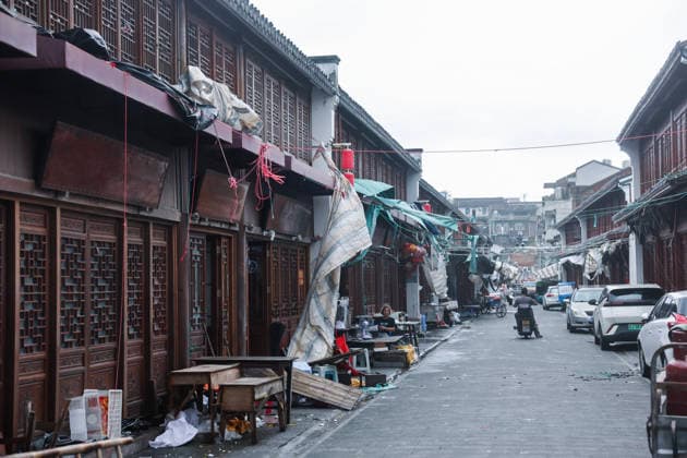 (260712) -- HANGZHOU, July 12, 2026 -- This photo taken on July 12, 2026 shows people on an historic street after the landing of Typhoon Bavi in Yuhuan of Taizhou City, east China s Zhejiang Province. Typhoon Bavi, the ninth typhoon of the year, landed on the coast of east China s Zhejiang Province at around 11:20 p.m. Saturday, according to the Zhejiang provincial meteorological observatory. The typhoon, with the maximum wind force at its center reaching 40 meters per second when landing, first churned ashore at Yuhuan City, a county-level city administered by the city of Taizhou, before making a second landfall in Yueqing City under the city of Wenzhou at around midnight. After landfall, the typhoon is expected to continue moving northwe 