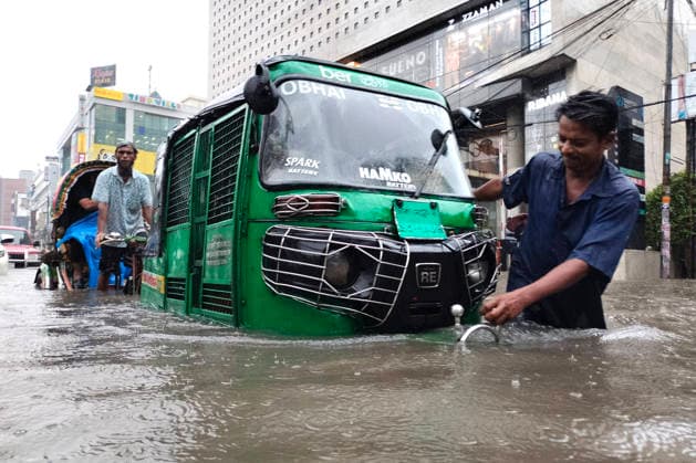 July 12, 2026, Dhaka, Dhaka, Bangladesh: DHAKA, Bangladesh, July 12, 2026 Ã¢â‚¬ Overnight heavy rainfall triggered widespread waterlogging across Dhaka on Sunday, disrupting daily life and causing severe hardship for residents...Several low-lying areas of the capital were submerged under knee- to waist-deep water, forcing commuters, schoolchildren, office workers and daily wage earners to wade through flooded streets. In several neighborhoods, mothers were seen carrying their children, while parents guided students by hand through waterlogged roads...The persistent rainfall caused severe traffic congestion on major roads across the capital, leaving many commuters stranded for hours and delaying travel. According to local residents, inade  - ZUMAk185 20260712_zip_k185_006 Copyright: xRubelxKarmakerx