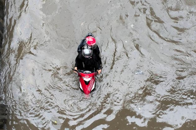 July 12, 2026, Dhaka, Dhaka, Bangladesh: DHAKA, Bangladesh, July 12, 2026 Ã¢â‚¬ Overnight heavy rainfall triggered widespread waterlogging across Dhaka on Sunday, disrupting daily life and causing severe hardship for residents...Several low-lying areas of the capital were submerged under knee- to waist-deep water, forcing commuters, schoolchildren, office workers and daily wage earners to wade through flooded streets. In several neighborhoods, mothers were seen carrying their children, while parents guided students by hand through waterlogged roads...The persistent rainfall caused severe traffic congestion on major roads across the capital, leaving many commuters stranded for hours and delaying travel. According to local residents, inade  - ZUMAk185 20260712_zip_k185_014 Copyright: xRubelxKarmakerx