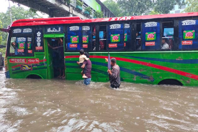 July 12, 2026, Dhaka, Dhaka, Bangladesh: DHAKA, Bangladesh, July 12, 2026 Ã¢â‚¬ Overnight heavy rainfall triggered widespread waterlogging across Dhaka on Sunday, disrupting daily life and causing severe hardship for residents...Several low-lying areas of the capital were submerged under knee- to waist-deep water, forcing commuters, schoolchildren, office workers and daily wage earners to wade through flooded streets. In several neighborhoods, mothers were seen carrying their children, while parents guided students by hand through waterlogged roads...The persistent rainfall caused severe traffic congestion on major roads across the capital, leaving many commuters stranded for hours and delaying travel. According to local residents, inade  - ZUMAk185 20260712_zip_k185_018 Copyright: xRubelxKarmakerx