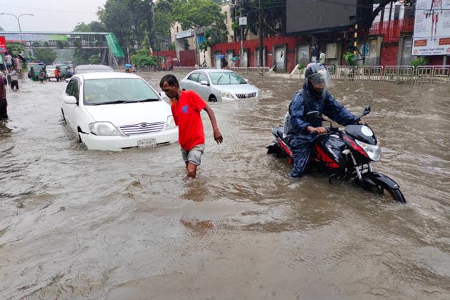 July 12, 2026, Dhaka, Dhaka, Bangladesh: DHAKA, Bangladesh, July 12, 2026 Ã¢â‚¬ Overnight heavy rainfall triggered widespread waterlogging across Dhaka on Sunday, disrupting daily life and causing severe hardship for residents...Several low-lying areas of the capital were submerged under knee- to waist-deep water, forcing commuters, schoolchildren, office workers and daily wage earners to wade through flooded streets. In several neighborhoods, mothers were seen carrying their children, while parents guided students by hand through waterlogged roads...The persistent rainfall caused severe traffic congestion on major roads across the capital, leaving many commuters stranded for hours and delaying travel. According to local residents, inade  - ZUMAk185 20260712_zip_k185_024 Copyright: xRubelxKarmakerx