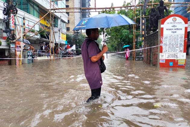 July 12, 2026, Dhaka, Dhaka, Bangladesh: DHAKA, Bangladesh, July 12, 2026 Ã¢â‚¬ Overnight heavy rainfall triggered widespread waterlogging across Dhaka on Sunday, disrupting daily life and causing severe hardship for residents...Several low-lying areas of the capital were submerged under knee- to waist-deep water, forcing commuters, schoolchildren, office workers and daily wage earners to wade through flooded streets. In several neighborhoods, mothers were seen carrying their children, while parents guided students by hand through waterlogged roads...The persistent rainfall caused severe traffic congestion on major roads across the capital, leaving many commuters stranded for hours and delaying travel. According to local residents, inade  - ZUMAk185 20260712_zip_k185_025 Copyright: xRubelxKarmakerx