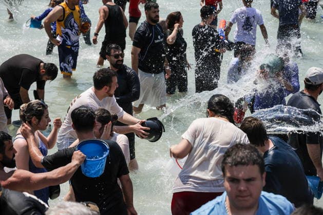ARMENIA, YEREVAN - JULY 12, 2026: Citizens collect bucketfuls of water from a fountain to douse each other in Republic Square during the traditional feast of Vardavar celebrated by the Armenian Apostolic Church to mark the Transfiguration of Christ Yerevan Armenia  - ZUMAt113 20260712_zaa_t113_256 Copyright: xAlexanderxPatrinx