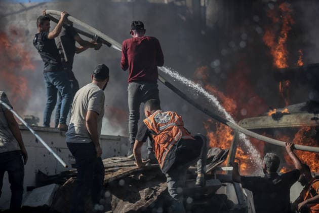 Israeli attacks on Gaza continue in violation of the ceasefire GAZA CITY, GAZA , PALESTINE - JULY 12: Rescuers try to extinguish a fire after the Israeli military targeted several buildings using unmanned aerial vehicles (UAVs) in Al-Sinaa (Industrial) Street in western Gaza City, Palestine on July 12, 2026. The drone-fired missiles caused significant damage and structural ruin across the residential and commercial area. Saeed M. M. T. Jaras Anadolu Gaza City Gaza. Editorial use only. Please get in touch for any other usage.  Copyright: x2026xAnadoluxSaeedxM.xM.xT.xJarasx