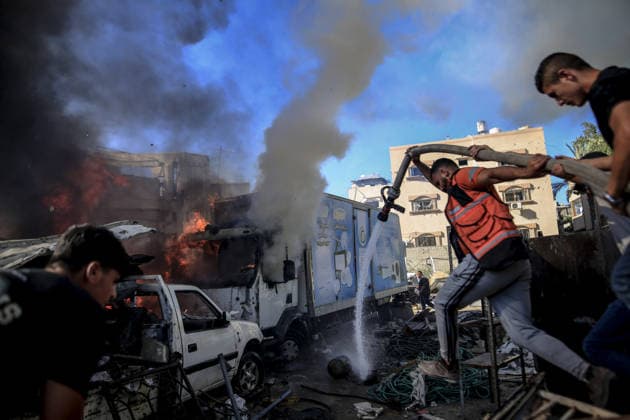 Israeli attacks on Gaza continue in violation of the ceasefire GAZA CITY, GAZA , PALESTINE - JULY 12: Palestinians rush as flame and thick smoke rise from a vehicle and destruction on Al-Sinaa (Industrial) Street in western Gaza City on July 12, 2026, after the Israeli military targeted several buildings using unmanned aerial vehicles (UAVs). The drone-fired missiles caused significant damage and structural ruin across the residential and commercial area. Saeed M. M. T. Jaras Anadolu Gaza City Gaza. Editorial use only. Please get in touch for any other usage.  Copyright: x2026xAnadoluxSaeedxM.xM.xT.xJarasx