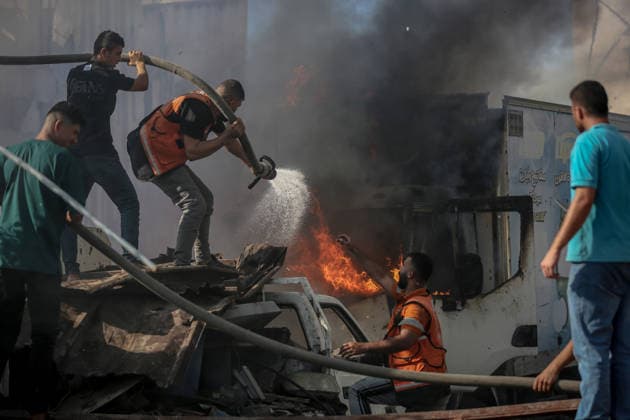 Israeli attacks on Gaza continue in violation of the ceasefire GAZA CITY, GAZA , PALESTINE - JULY 12: Rescuers try to extinguish a fire after the Israeli military targeted several buildings using unmanned aerial vehicles (UAVs) in Al-Sinaa (Industrial) Street in western Gaza City, Palestine on July 12, 2026. The drone-fired missiles caused significant damage and structural ruin across the residential and commercial area. Saeed M. M. T. Jaras Anadolu Gaza City Gaza. Editorial use only. Please get in touch for any other usage.  Copyright: x2026xAnadoluxSaeedxM.xM.xT.xJarasx
