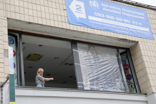 RECORD DATE NOT STATED A woman stands at a window partially covered with protective film after a Russian ballistic missile strike in the Darnytskyi district of Kyiv, Ukraine, on July 11, 2026. During the night of July 11, Russian forces launched their third ballistic missile attack on Kyiv in a week. Twelve people, including two children aged 10 and 11, were injured (Photo by Yuliia Ovsiannikova Ukrinform) Cleanup underway after Russian attack in Darnytskyi district of Kyiv  Copyright: xYuliiaxOvsiannikovax