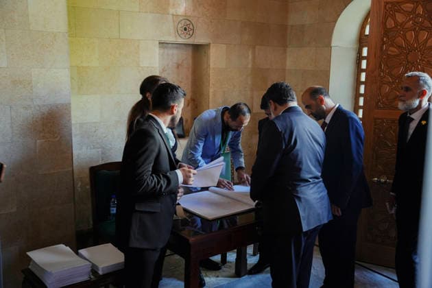 Damascus Syria Parliament First Session Members of Syria s People s Assembly check documents before the first session of the country s new parliament in Damascus, Syria, on July 12, 2026. The 210-member assembly is Syria s first parliament since the fall of the Assad government in December 2024 and is tasked with legislating during the transitional period. Damascus Damascus Syria Copyright: xOmarxAlbamx
