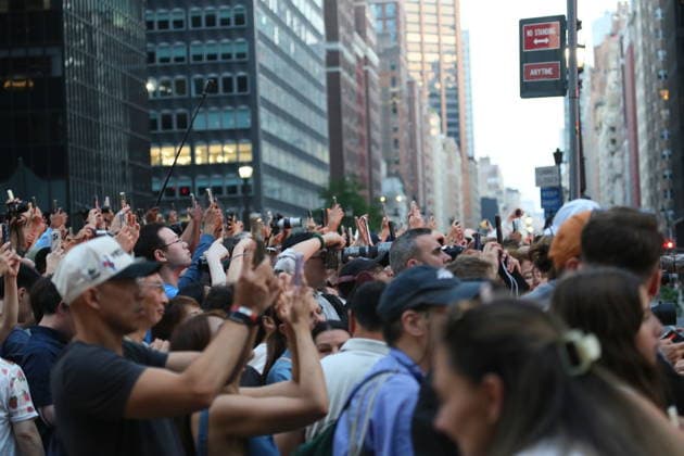 (260713) -- NEW YORK, July 13, 2026 -- People take photos of the Manhattanhenge in Manhattan of New York, the United States, on July 12, 2026. The Manhattanhenge refers to the twice-a-year circumstance during which the setting sun aligns precisely with the east-west streets of Manhattan. ) U.S.-NEW YORK-MANHATTANHENGE ZhangxFengguo 