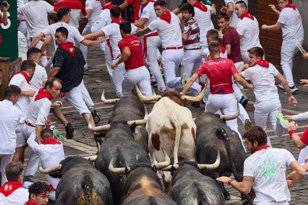 July 13, 2026, Pamplona, Navarre, Spain: People take part in the traditional encierro (bull-run) of the San Fermin Festival in Pamplona, Spain on July 13, 2026. The bull-running fiesta is held annually from 06 to 14 July in commemoration of the city s patron saint. Visitors from all over the world attend the festival. Many of them physically participate in the highlight event - the running of the bulls, or encierro - where they attempt to outrun the animals along a route through the narrow streets of Pamplona s old city. Pamplona Spain - ZUMAa206 20260713_zsp_a206_009 Copyright: xRubenxAlbarranx