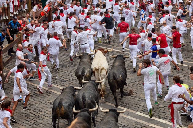 July 13, 2026, Pamplona, Navarre, Spain: People take part in the traditional encierro (bull-run) of the San Fermin Festival in Pamplona, Spain on July 13, 2026. The bull-running fiesta is held annually from 06 to 14 July in commemoration of the city s patron saint. Visitors from all over the world attend the festival. Many of them physically participate in the highlight event - the running of the bulls, or encierro - where they attempt to outrun the animals along a route through the narrow streets of Pamplona s old city. Pamplona Spain - ZUMAa206 20260713_zsp_a206_014 Copyright: xRubenxAlbarranx