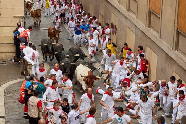 July 13, 2026, Pamplona, Navarre, Spain: People take part in the traditional encierro (bull-run) of the San Fermin Festival in Pamplona, Spain on July 13, 2026. The bull-running fiesta is held annually from 06 to 14 July in commemoration of the city s patron saint. Visitors from all over the world attend the festival. Many of them physically participate in the highlight event - the running of the bulls, or encierro - where they attempt to outrun the animals along a route through the narrow streets of Pamplona s old city. Pamplona Spain - ZUMAa206 20260713_zsp_a206_024 Copyright: xRubenxAlbarranx