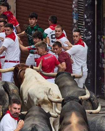 July 13, 2026, Pamplona, Navarre, Spain: People take part in the traditional encierro (bull-run) of the San Fermin Festival in Pamplona, Spain on July 13, 2026. The bull-running fiesta is held annually from 06 to 14 July in commemoration of the city s patron saint. Visitors from all over the world attend the festival. Many of them physically participate in the highlight event - the running of the bulls, or encierro - where they attempt to outrun the animals along a route through the narrow streets of Pamplona s old city. Pamplona Spain - ZUMAa206 20260713_zsp_a206_034 Copyright: xRubenxAlbarranx