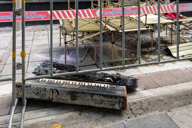 July 13, 2026, Bangkok, Thailand: A view of a burned keyboard on the sidewalk beneath dangerous area warning tape outside the Rong Beer Na Lat Phrao pub after the fire on Lat Phrao Road in Bangkok. The aftermath of a deadly fire at the Rong Beer Na Lat Phrao pub in Bangkok on 13 July 2026. The blaze killed at least 27 people and injured dozens. Authorities are investigating the cause of the fire. Bangkok Thailand - ZUMAs197 20260713_aaa_s197_016 Copyright: xNathaliexJamoisx