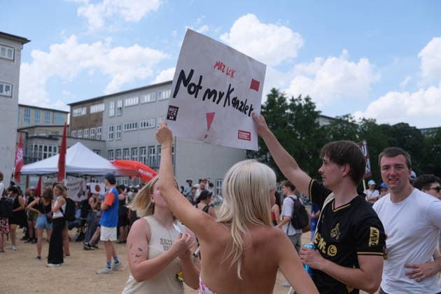 Protesters rally against German Chancellor Merz in Cologne COLOGNE, GERMANY - JULY 13: Demonstrators gather outside the University of Cologne during a protest while German Chancellor Friedrich Merz attends the official inauguration of the Adenauer School of Government in Cologne, Germany, on July 13, 2026. Around 4,000 people joined the demonstration, organized by the university s AStA together with student organizations, trade unions and political groups, criticizing the chancellor s domestic policies, migration policy, social reforms and Germany s support for Israel. Merz participated in the opening ceremony under heightened security while protesters marched and rallied near the university campus. Mouafak Mahmalji Anadolu Cologne German  Copyright: x2026xAnadoluxMouafakxMahmaljix