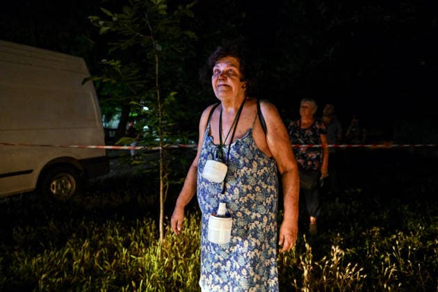 RECORD DATE NOT STATED A woman looks at a residential building damaged in a nighttime Russian attack in Zaporizhzhia, Ukraine, on July 12, 2026. Six people, including a 15-year-old boy, were injured in the attack(Photo by Dmytro Smolienko Ukrinform) Nighttime Russian drone strike hits Zaporizhzhia  Copyright: xDmytroxSmolienkox