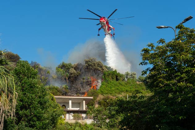 Wildfire erupts near Campi Flegrei volcanic area in Italy POZZUOLI, ITALY - JULY 13: An helicopter drops water over a wildfire on the outer edge of the Solfatara volcanic crater in the Campi Flegrei (Phlegraean Fields) volcanic region in Pozzuoli on July 13, 2026. The fire broke out in the undergrowth and quickly spread in the Pisciarelli area to several car dealerships, causing fuel tanks and tyres to explode. Eliano Imperato Anadolu Pozzuoli Italy. Editorial use only. Please get in touch for any other usage.  Copyright: x2026xAnadoluxElianoxImperatox