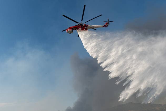 Wildfire erupts near Campi Flegrei volcanic area in Italy POZZUOLI, ITALY - JULY 13: An helicopter drops water over a wildfire in the Pisciarelli area located on the outer edge of the Solfatara volcanic crater in the Campi Flegrei (Phlegraean Fields) volcanic region in Pozzuoli on July 13, 2026. The fire broke out in the undergrowth and quickly spread to several car dealerships, causing fuel tanks and tyres to explode. Eliano Imperato Anadolu Pozzuoli Italy. Editorial use only. Please get in touch for any other usage.  Copyright: x2026xAnadoluxElianoxImperatox