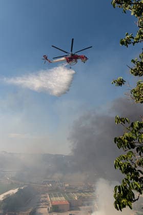 Wildfire erupts near Campi Flegrei volcanic area in Italy POZZUOLI, ITALY - JULY 13: An helicopter drops water over a wildfire in the Pisciarelli area located on the outer edge of the Solfatara volcanic crater in the Campi Flegrei (Phlegraean Fields) volcanic region in Pozzuoli on July 13, 2026. The fire broke out in the undergrowth and quickly spread to several car dealerships, causing fuel tanks and tyres to explode. Eliano Imperato Anadolu Pozzuoli Italy. Editorial use only. Please get in touch for any other usage.  Copyright: x2026xAnadoluxElianoxImperatox