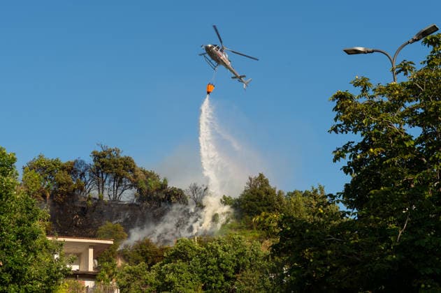 Wildfire erupts near Campi Flegrei volcanic area in Italy POZZUOLI, ITALY - JULY 13: An helicopter drops water over a wildfire on the outer edge of the Solfatara volcanic crater in the Campi Flegrei (Phlegraean Fields) volcanic region in Pozzuoli on July 13, 2026. The fire broke out in the undergrowth and quickly spread in the Pisciarelli area to several car dealerships, causing fuel tanks and tyres to explode. Eliano Imperato Anadolu Pozzuoli Italy. Editorial use only. Please get in touch for any other usage.  Copyright: x2026xAnadoluxElianoxImperatox