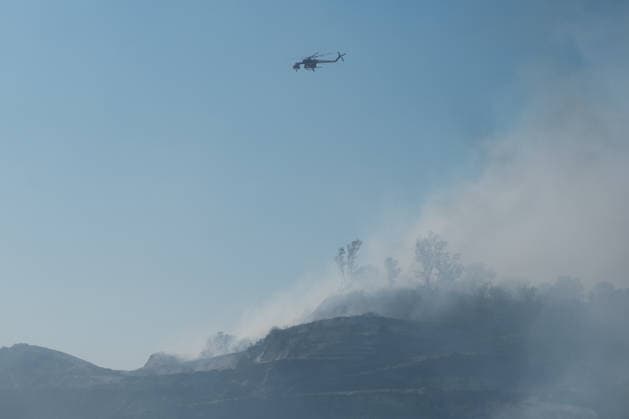 Wildfire erupts near Campi Flegrei volcanic area in Italy POZZUOLI, ITALY - JULY 13: An helicopter flights over a wildfire in the Pisciarelli area located on the outer edge of the Solfatara volcanic crater in the Campi Flegrei (Phlegraean Fields) volcanic region in Pozzuoli on July 13, 2026. The fire broke out in the undergrowth and quickly spread to several car dealerships, causing fuel tanks and tyres to explode. Eliano Imperato Anadolu Pozzuoli Italy. Editorial use only. Please get in touch for any other usage.  Copyright: x2026xAnadoluxElianoxImperatox