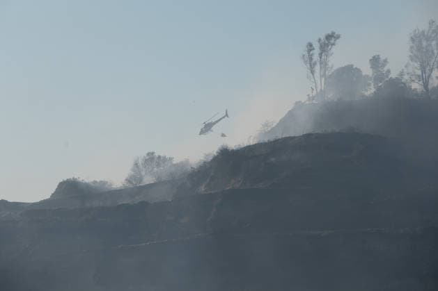 Wildfire erupts near Campi Flegrei volcanic area in Italy POZZUOLI, ITALY - JULY 13: An helicopter flights over a wildfire in the Pisciarelli area located on the outer edge of the Solfatara volcanic crater in the Campi Flegrei (Phlegraean Fields) volcanic region in Pozzuoli on July 13, 2026. The fire broke out in the undergrowth and quickly spread to several car dealerships, causing fuel tanks and tyres to explode. Eliano Imperato Anadolu Pozzuoli Italy. Editorial use only. Please get in touch for any other usage.  Copyright: x2026xAnadoluxElianoxImperatox