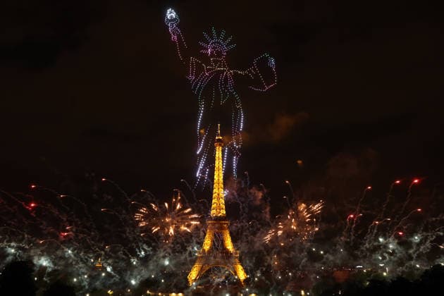 Fireworks and drones light the Eiffel Tower during the Bastille Day celebrations in Paris, France, on Monday, July 13, 2026. The municipality brought the event a day earlier so as to dedicate entirely July 14, 2026 to a national tribute marking the 10th anniversary of the Nice attack when 86 people were killed.  PAR20260713104 MAYAxVIDON-WHITE