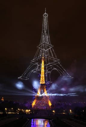 Fireworks and drones light the Eiffel Tower during the Bastille Day celebrations in Paris, France, on Monday, July 13, 2026. The municipality brought the event a day earlier so as to dedicate entirely July 14, 2026 to a national tribute marking the 10th anniversary of the Nice attack when 86 people were killed.  PAR20260713113 MAYAxVIDON-WHITE