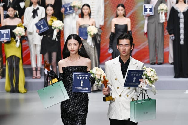 JIAXING, CHINA - JULY 13: Li Ruoyuan (L) and Hu Zhihao (R), winners of the championship, walk the runway during the 20th CSM Super Model Contest National Final on July 13, 2026 in Jiaxing, Zhejiang Province of China. The national final of the 20th CSM Super Model Contest was held in Haining, a county-level city under Jiaxing.  Copyright: xChinaxNewsxServicex 111654156008