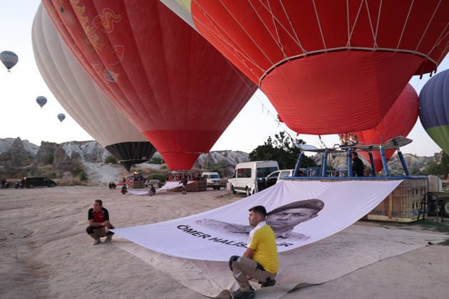 Cappadocia commemorates martyrs of 2016 defeated coup attempt NEVSEHIR, TURKIYE - JULY 14: Hot air balloons take off in Cappadocia carrying Turkish flags and banners featuring photographs of the 253 martyrs to commemorate July 15 Democracy and National Unity Day in Nevsehir, Turkiye on July 14, 2026. As part of the event organized by the Nevsehir Governorship, banners displaying Turkish flags and photographs of the martyrs were attached to the hot air balloons. Behcet Alkan Anadolu Nevsehir Turkey. Editorial use only. Please get in touch for any other usage.  Copyright: x2026xAnadoluxBehcetxAlkanx