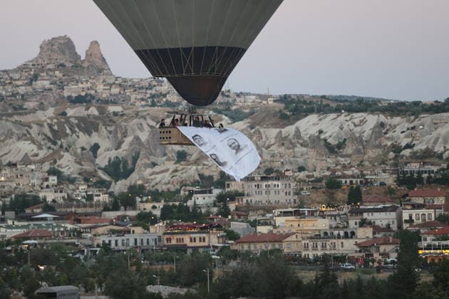 Cappadocia commemorates martyrs of 2016 defeated coup attempt NEVSEHIR, TURKIYE - JULY 14: Hot air balloons take off in Cappadocia carrying Turkish flags and banners featuring photographs of the 253 martyrs to commemorate July 15 Democracy and National Unity Day in Nevsehir, Turkiye on July 14, 2026. As part of the event organized by the Nevsehir Governorship, banners displaying Turkish flags and photographs of the martyrs were attached to the hot air balloons. Behcet Alkan Anadolu Nevsehir Turkey. Editorial use only. Please get in touch for any other usage.  Copyright: x2026xAnadoluxBehcetxAlkanx